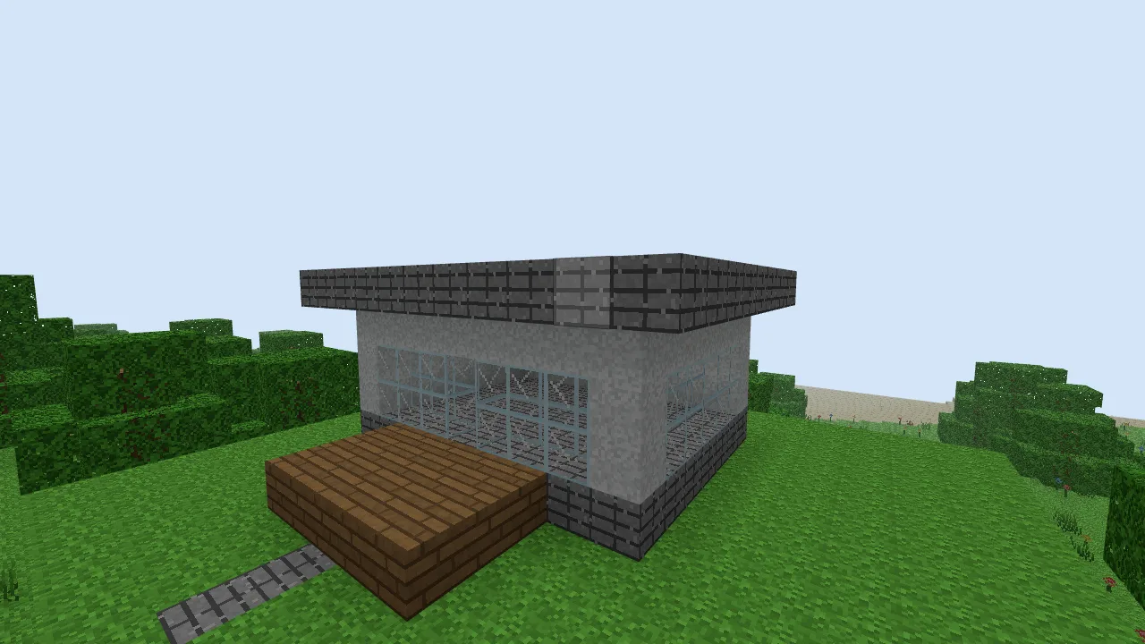 The completed white house, with broad glass panels, a dark roof overhang and a wooden porch.
